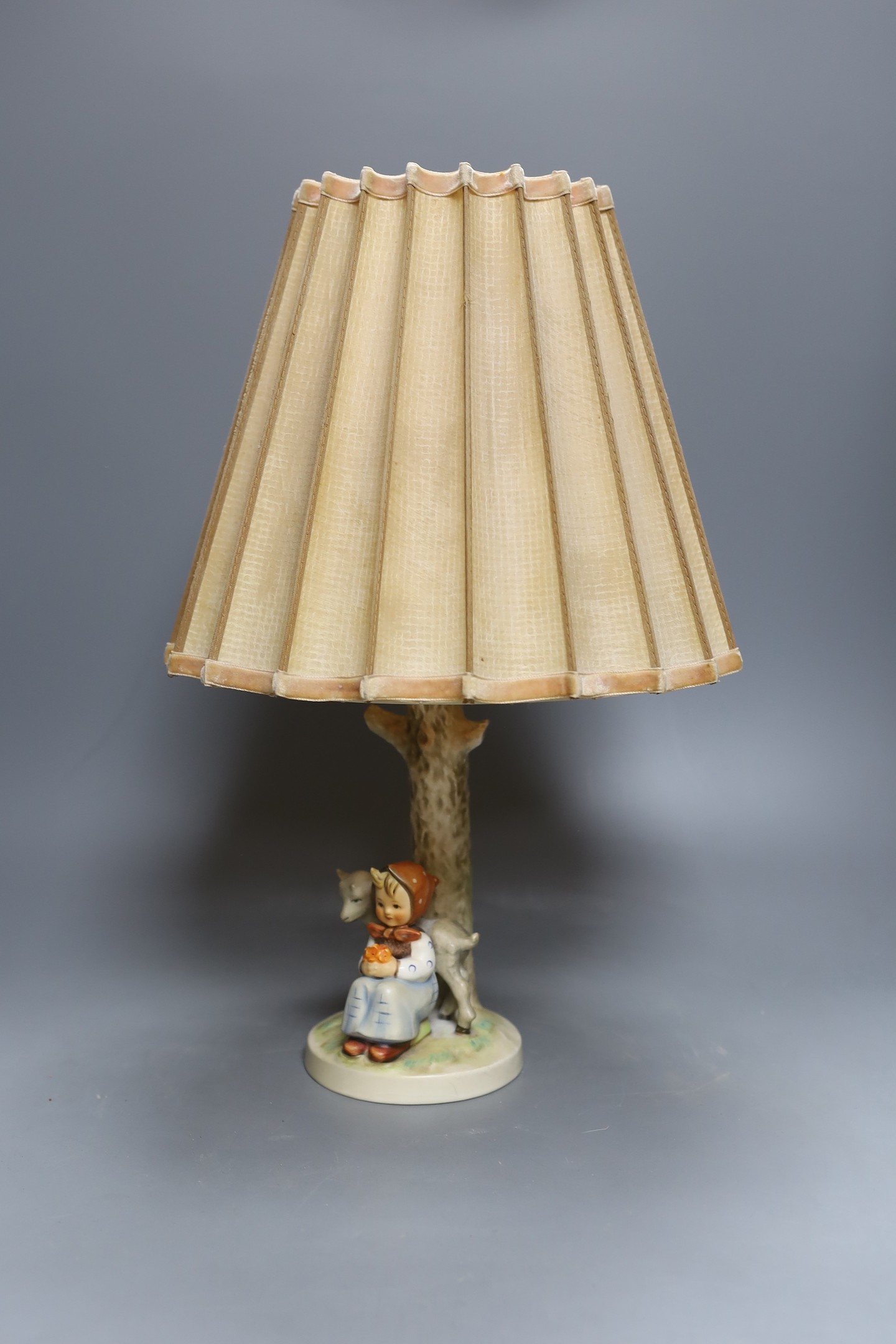 A Hummel figural table lamp, 43 cms high including shade.